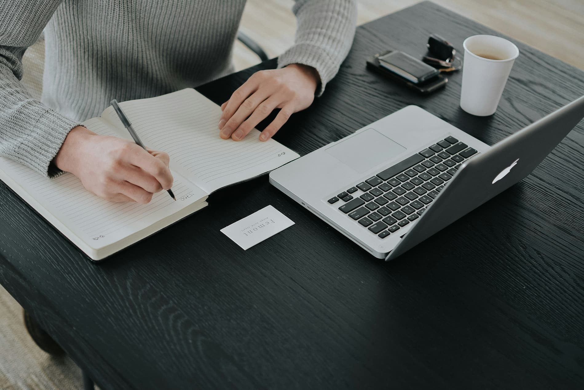 Technical documentation writer creating process documentation and business procedures on a laptop.