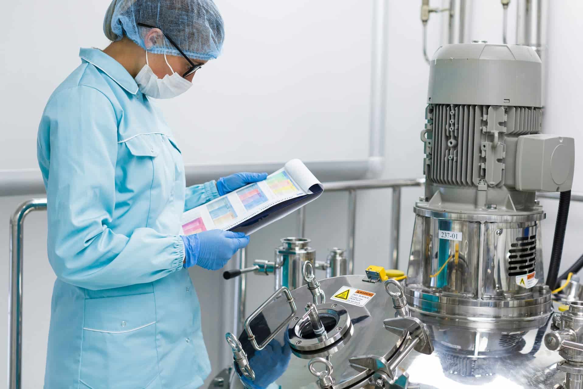 Biotechnology technical writer reviewing documentation in a biopharmaceutical manufacturing facility