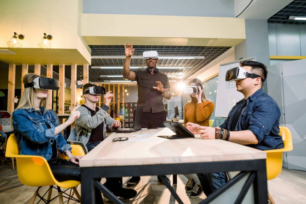 Diverse group of professionals wearing virtual reality headsets during an immersive workplace training session.